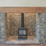 large fireplace alcove with wood burning stove within