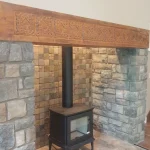large fireplace alcove with wood burning stove within angled shot