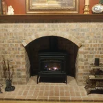 gas powered fireplace with wooden mantle