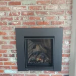 gas powered fireplace in brick wall close up