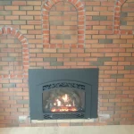 gas powered fireplace in brick wall