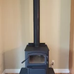 wood burning stove in corner of room close up