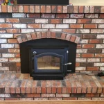 multi-colored brick wood burning fireplace