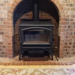 wood burning fireplace set in brick alcove