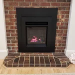 gas powered fireplace with brick surrounding