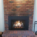 gas powered fireplace with brick surrounding