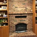 fireplace with full length bookcases surrounding after